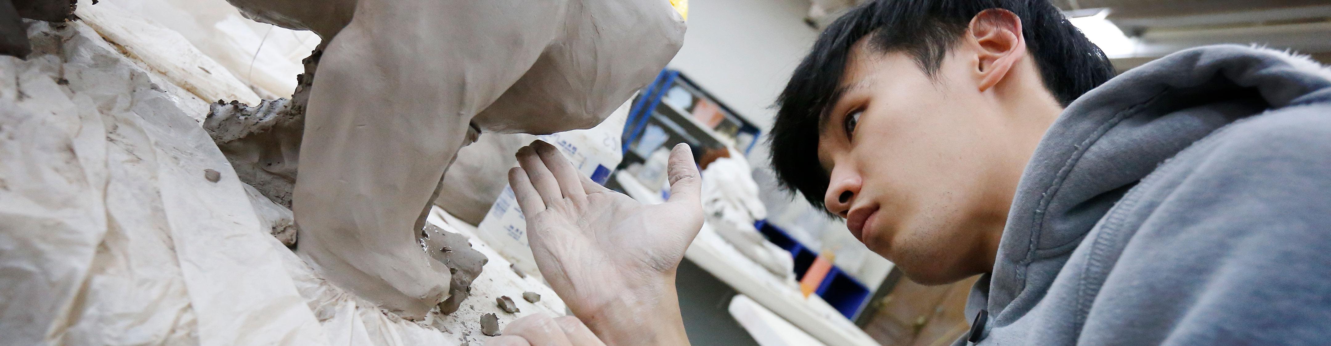 International 正规博彩平台 student making a sculpture